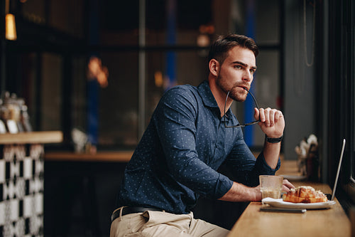 Businessman sitting in a restaurant working on laptop