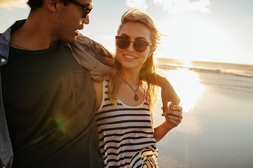 Woman with boyfriend on beach.