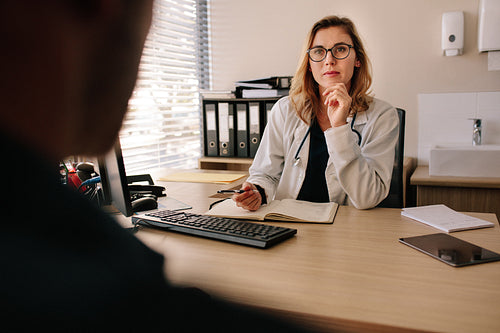 Female doctor listening to problems of her patient