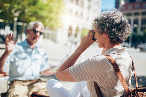 Senior woman photographing her husband