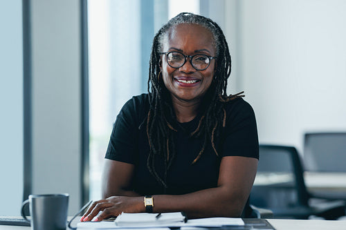 African business woman looking at the camera with confidence in her office