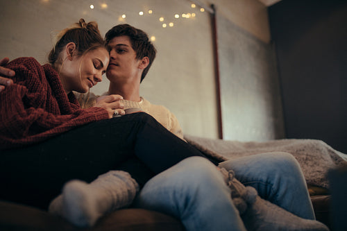 Romantic man and woman relaxing in living room