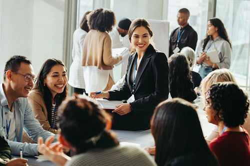 Diverse business team collaborates on strategy in a modern office environment with teamwork and innovation at the forefront