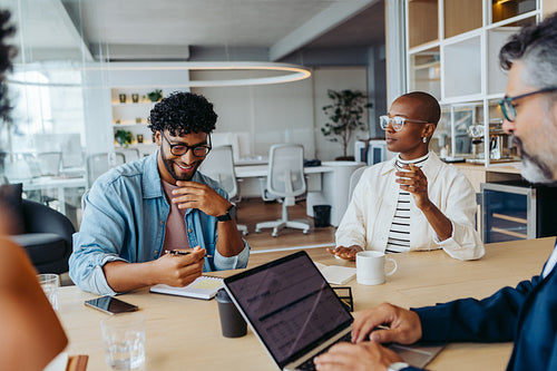 Business colleagues brainstorming ideas in a collaborative boardroom meeting