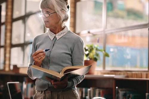 Senior female professor teaching in classroom