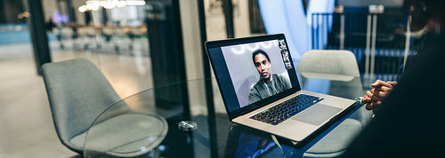 Unrecognizable businesswoman attending a virtual meeting in an office