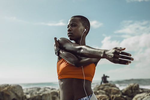 Fitness woman exercising at the beach