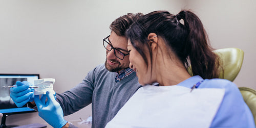 Dentist demonstrating dental care to patient