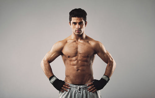 Young muscular man posing confidently