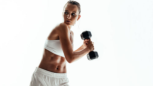 Tough woman doing workout with dumbbells