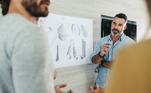 Creative businesspeople working with design drawings in an office