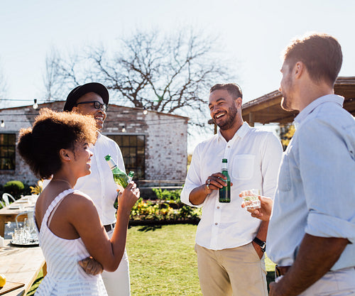 Cheerful group of friends having a party outdoors