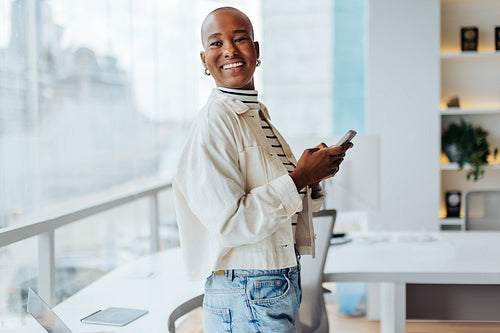 Successful businesswoman using a smartphone for business communication in office