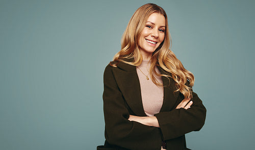 Cheerful woman smiling at the camera in a studio