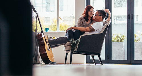 Affectionate couple relaxing on armchair