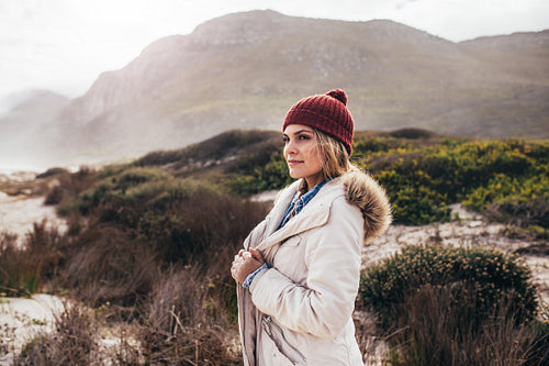 Woman standing on the beach in winter