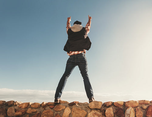 Excited man standing on embankment along the roadside