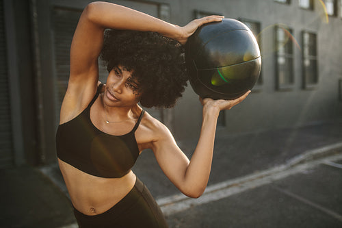 Fit woman exercising with fitness ball