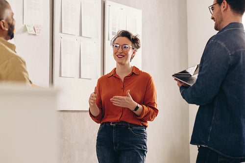 Happy businesswoman having a discussion with her team