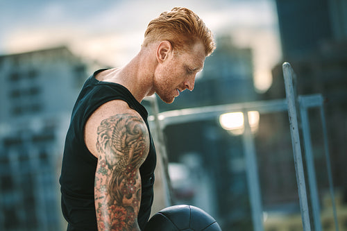 Close up of a fitness man doing workout with a medicine ball