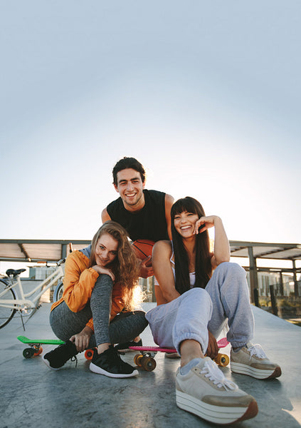Group of friends hanging out at skate park