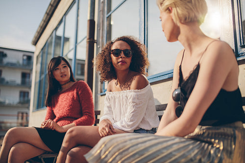 Three young female friends meeting outdoors