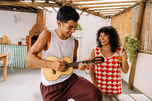 Two friends enjoying music with a cavaquinho in Rio de Janeiro