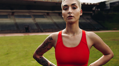 Portrait of a female athlete standing in a stadium