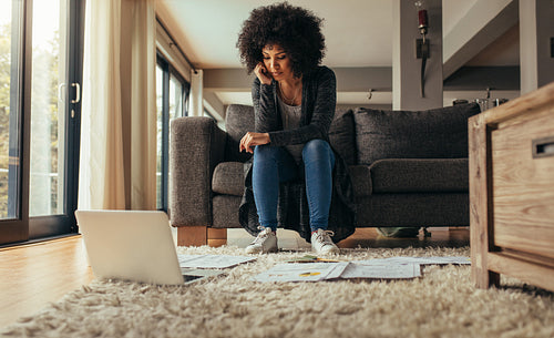 Woman at home studying business papers