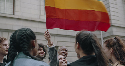 Group of people proudly looking at LGBT flag at Gay parade