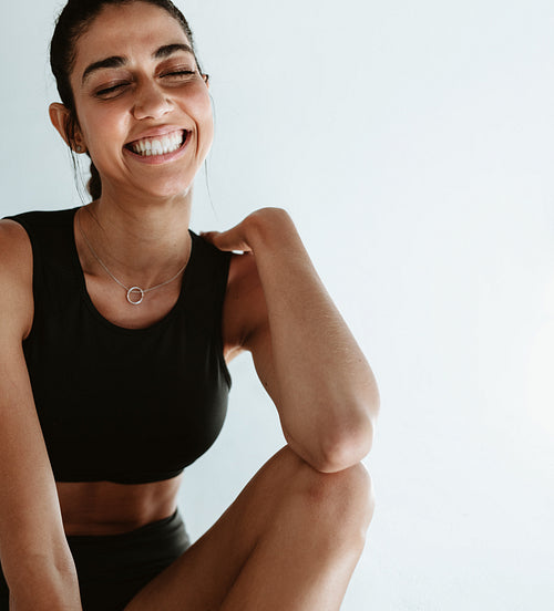 Happy fitness woman taking a break from workout