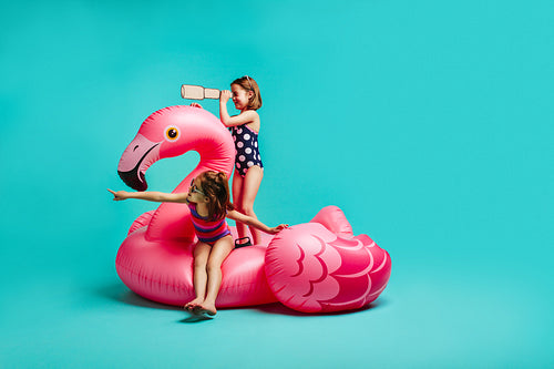 Two girls playing on inflatable toy