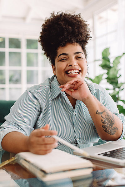 Woman smiling while sitting at desk