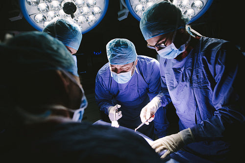 Team of professional surgeons performing surgery