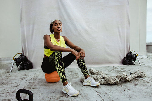 African sportswoman relaxing after workout