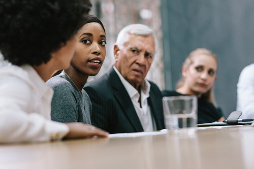 Woman sharing her ideas during staff meeting