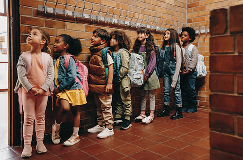 Primary school students waiting in line outside their classroom. Children waiting to start class in the morning