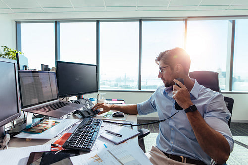Business investor sitting at his desk in office.