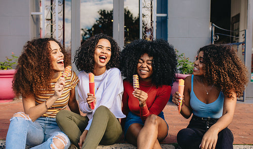 Girls enjoying ice lollies 