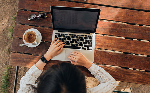 Woman using her laptop at a coffee shop