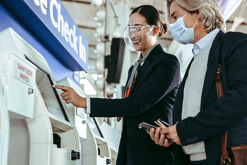 Self check in at airport with ground attendant