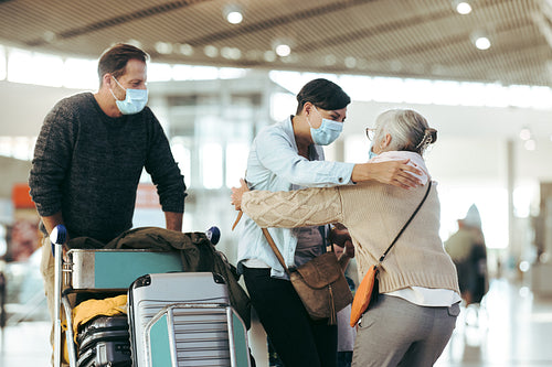 Senior woman receiving her family at airport arrival