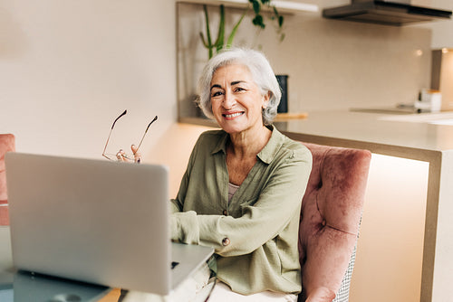 Silver-haired senior businesswoman working in her home office