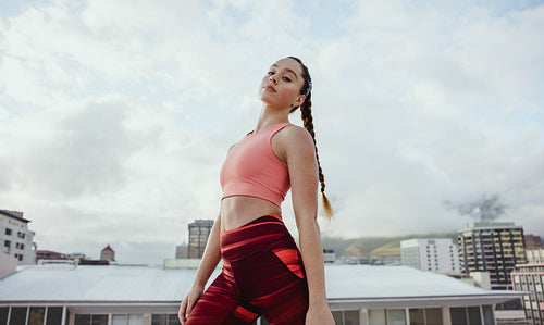Fitness woman exercising on rooftop