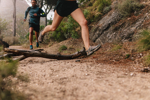 Young people running on country trail path