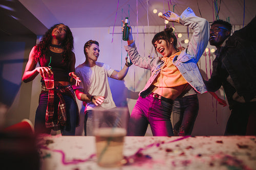 Friends dancing the night away at a house party
