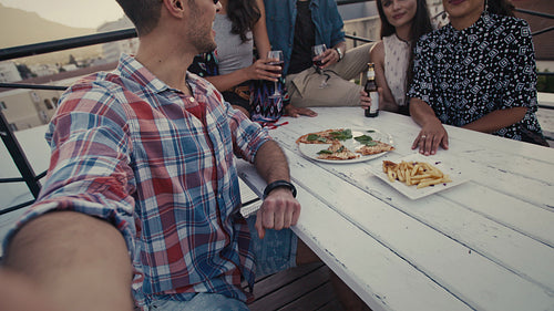 Friends making a selfie at rooftop party