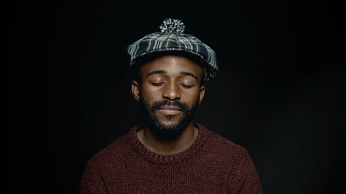 Man in a cap with his eyes closed