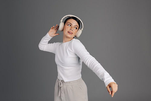 Woman dancing to her favourite music in a studio