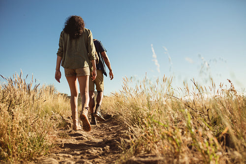 Couple trekking on a rocky hillock